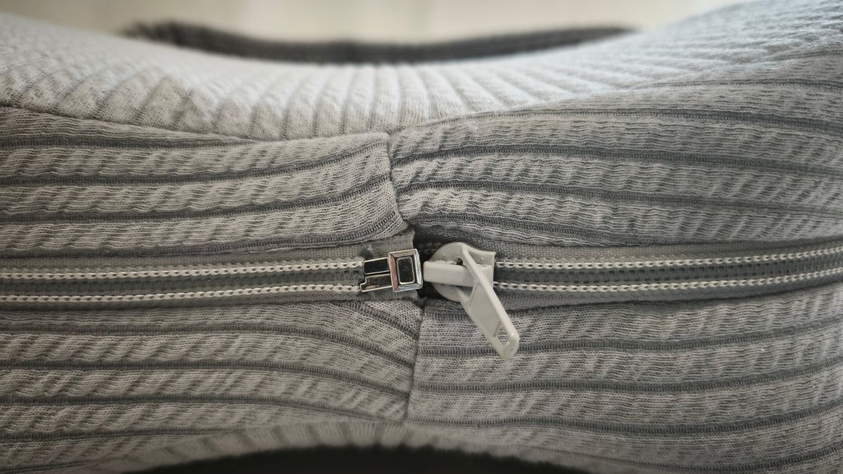Close-up of the two-way zip on the Butterfly Knee Pillow's removable cover
