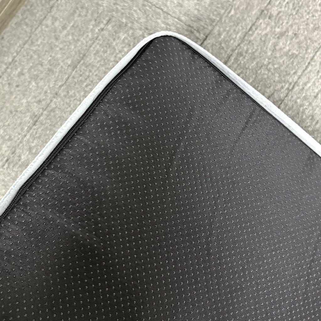 Underside of the dog bed showing the full-area non-slip dotted base